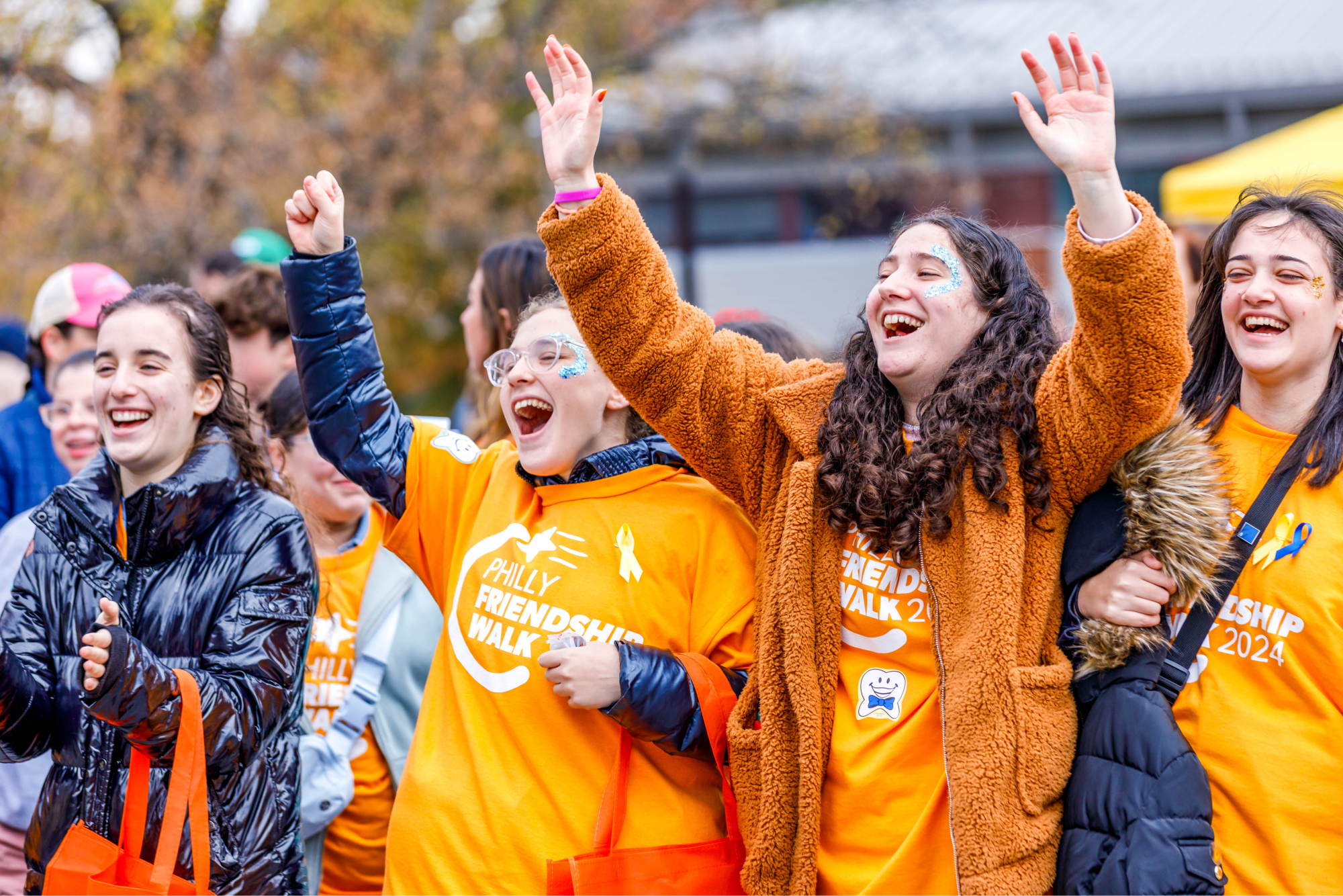 teens cheering with hands in the air