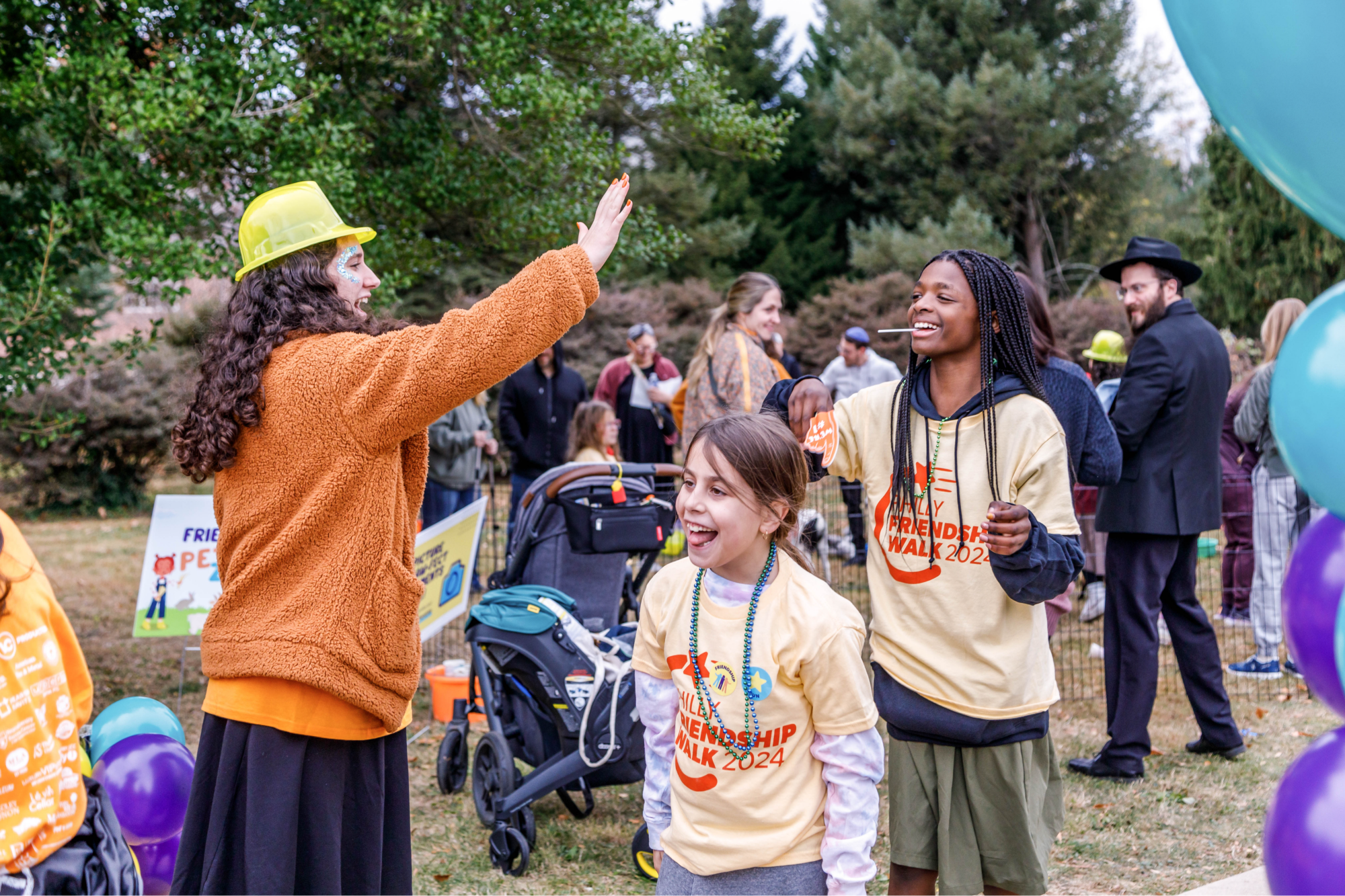 people walking together, smiling, and high fiving