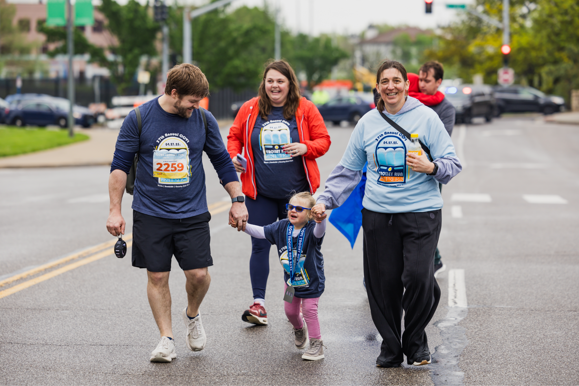 family walking with visually impaired daughter and therapist