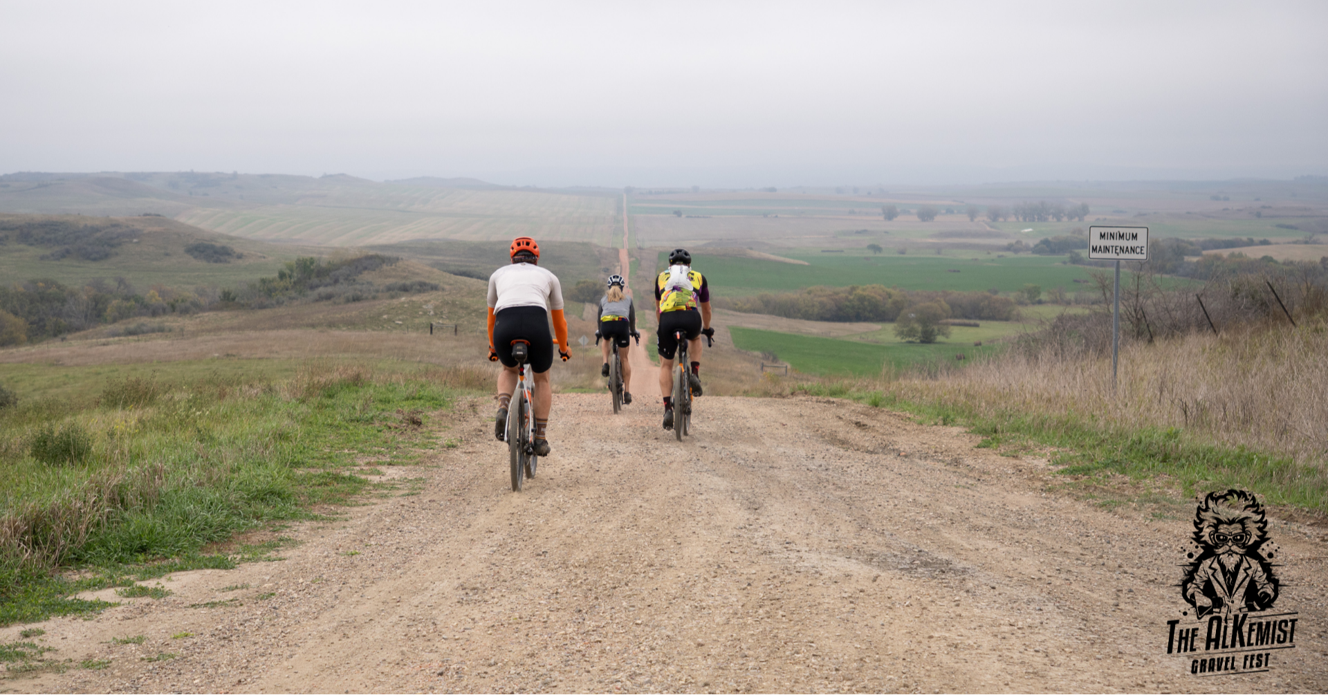 Cyclists riding down a gravel road