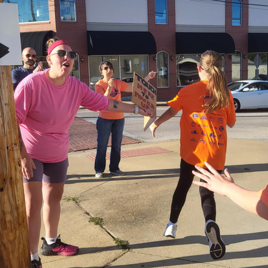 Volunteers cheering on runners