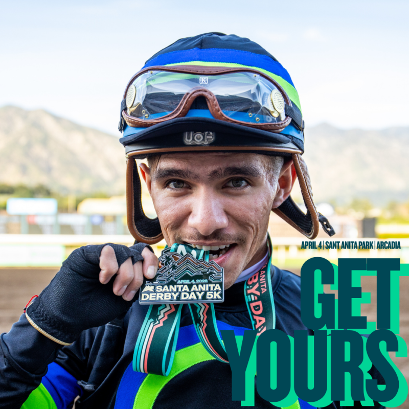 a jockey biting on a medal at the race track 