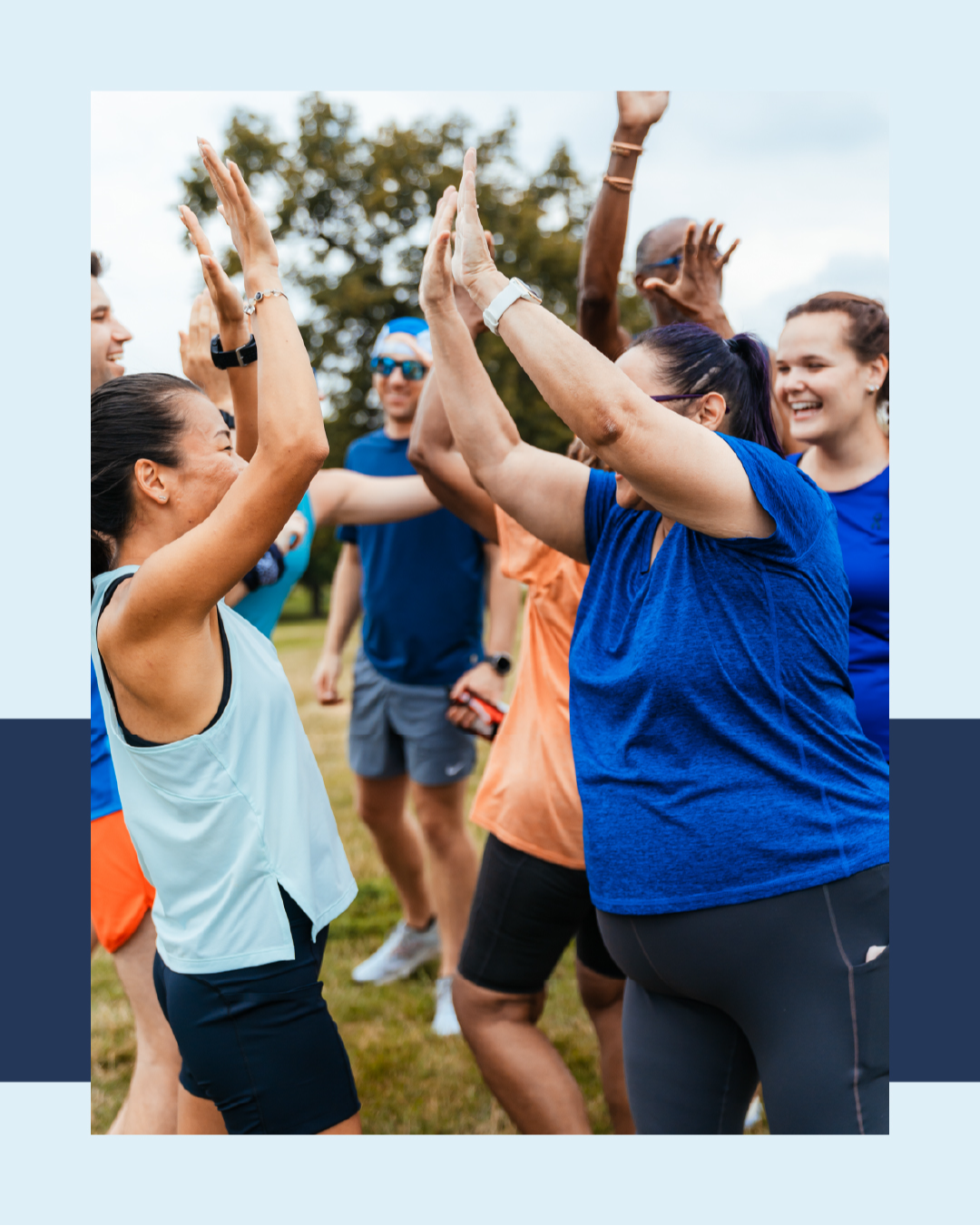 group of people with two women giving each other a high five to celebrate!