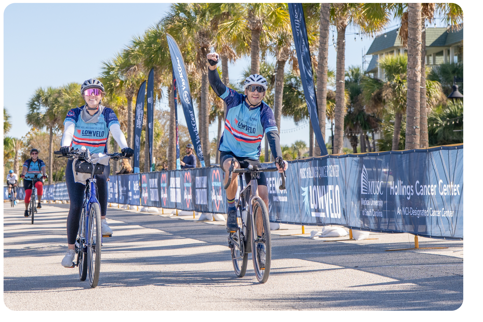 Cyclists crossing the finish line with excitement at Lowvelo