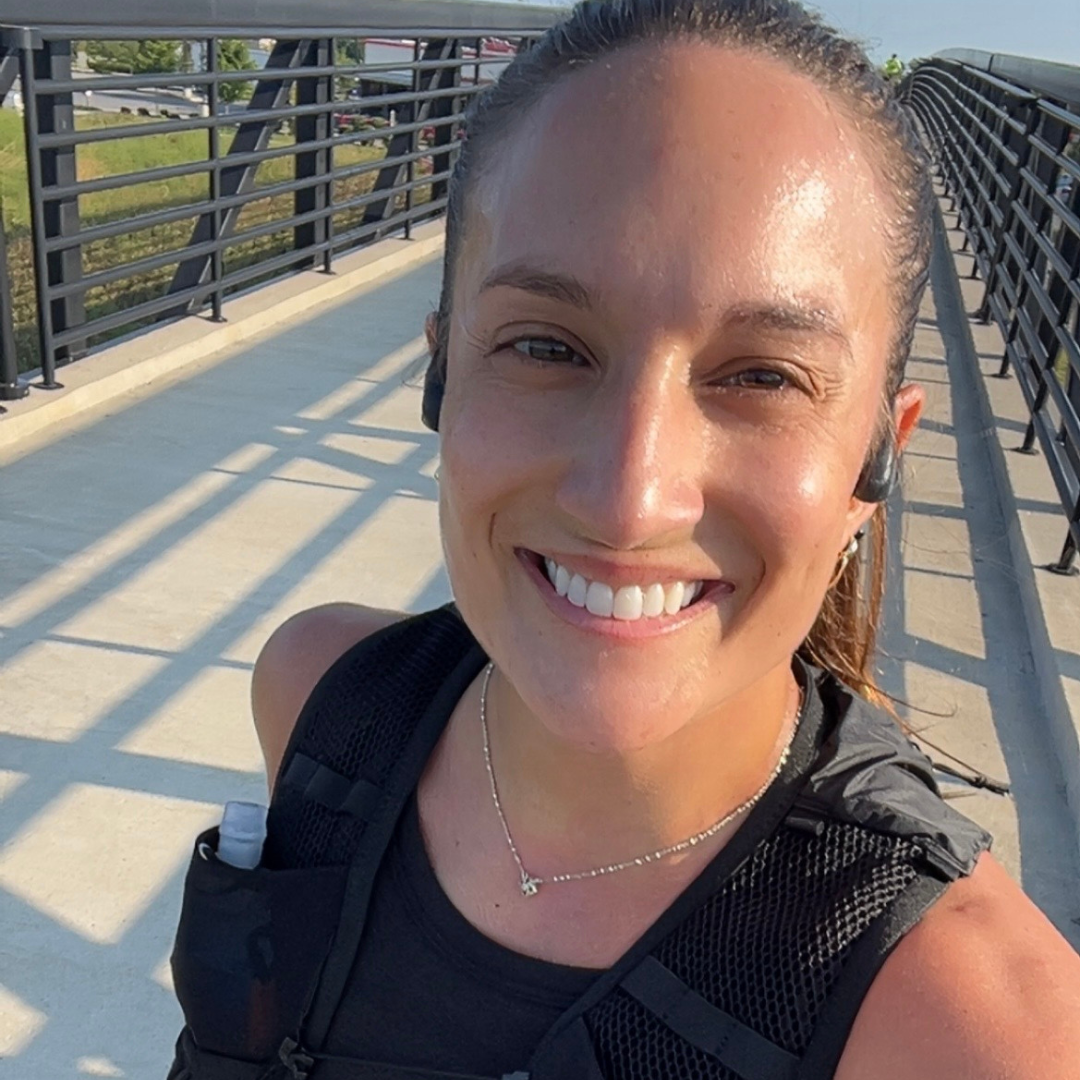 leah test posing on a bridge while running