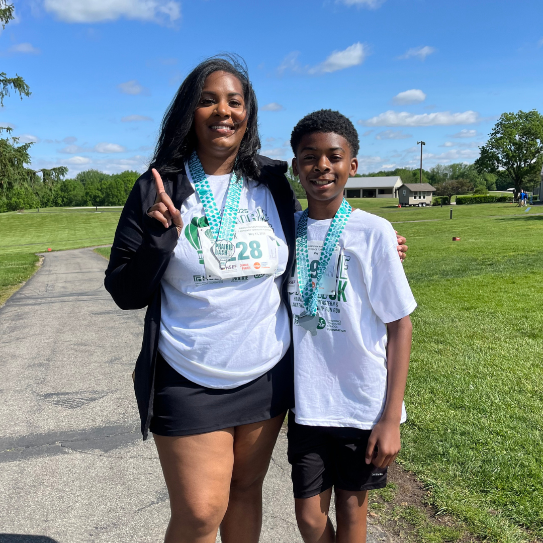 katrina satanding at the prairie dash with her son