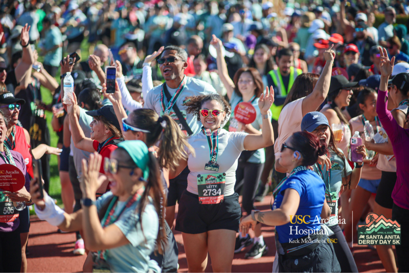 a group of people celebrating after completing a race