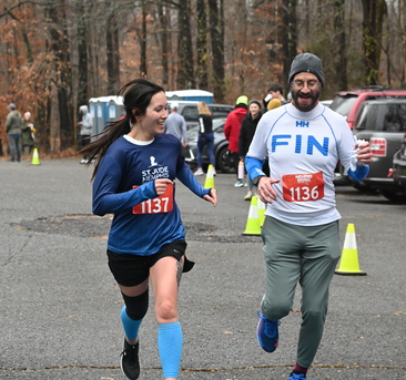 man and woman finishing the race