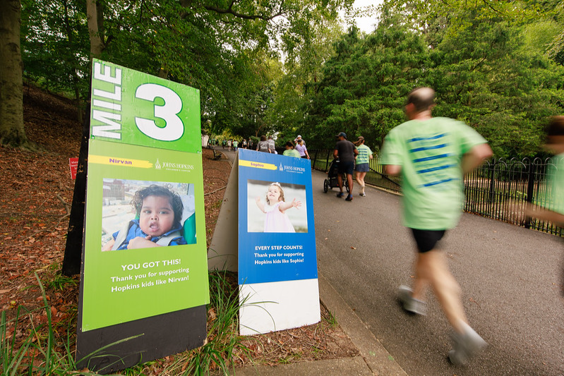 Mile motivator signs on the 5K course