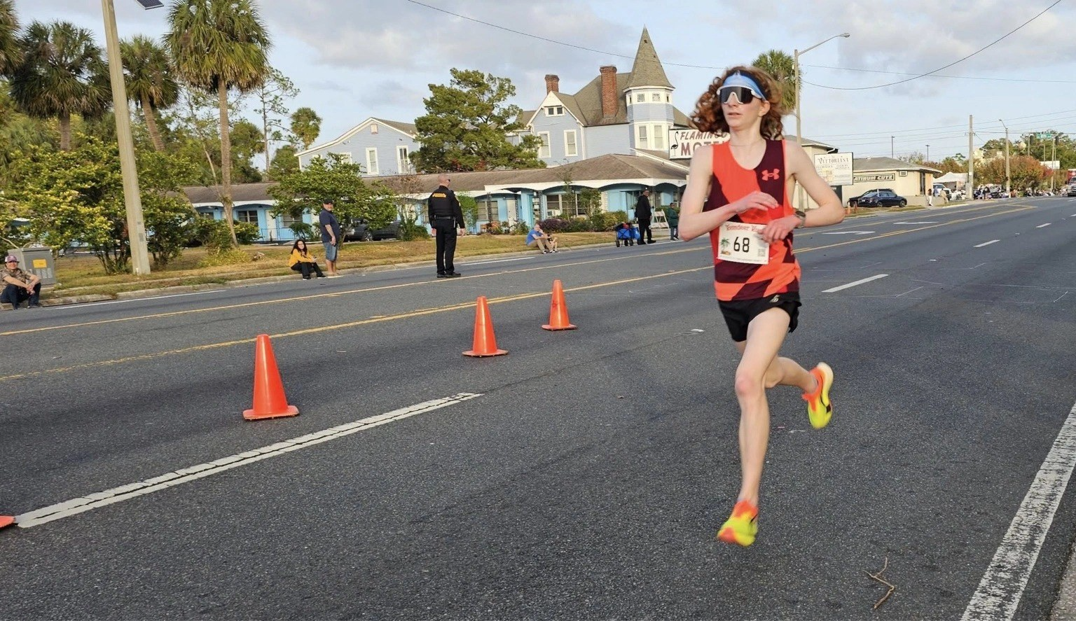 A runner racing down Silver Springs Boulevard at the Ocala Reindeer Run