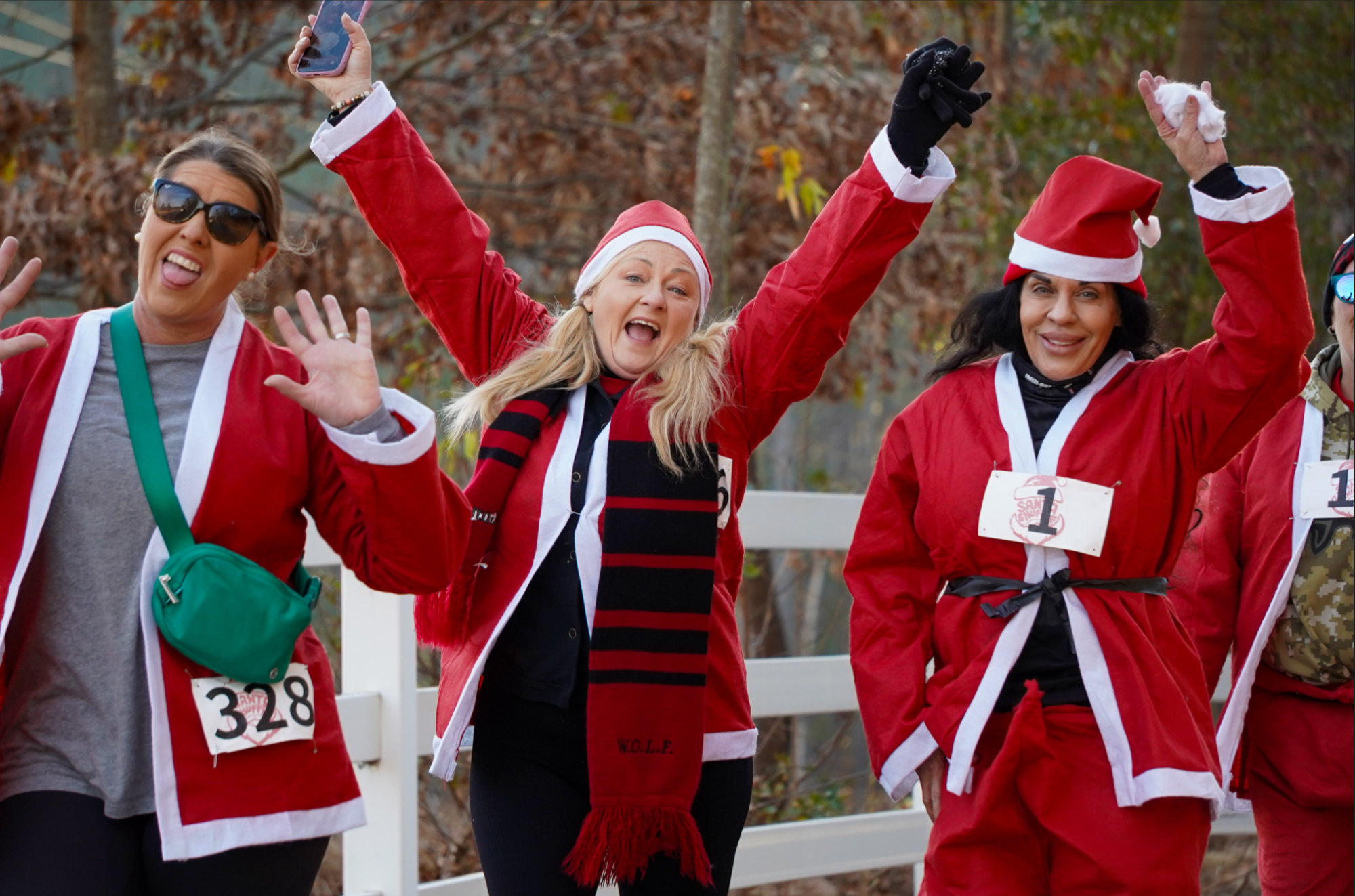 Women walking the course excited to be celebrating in santa suits