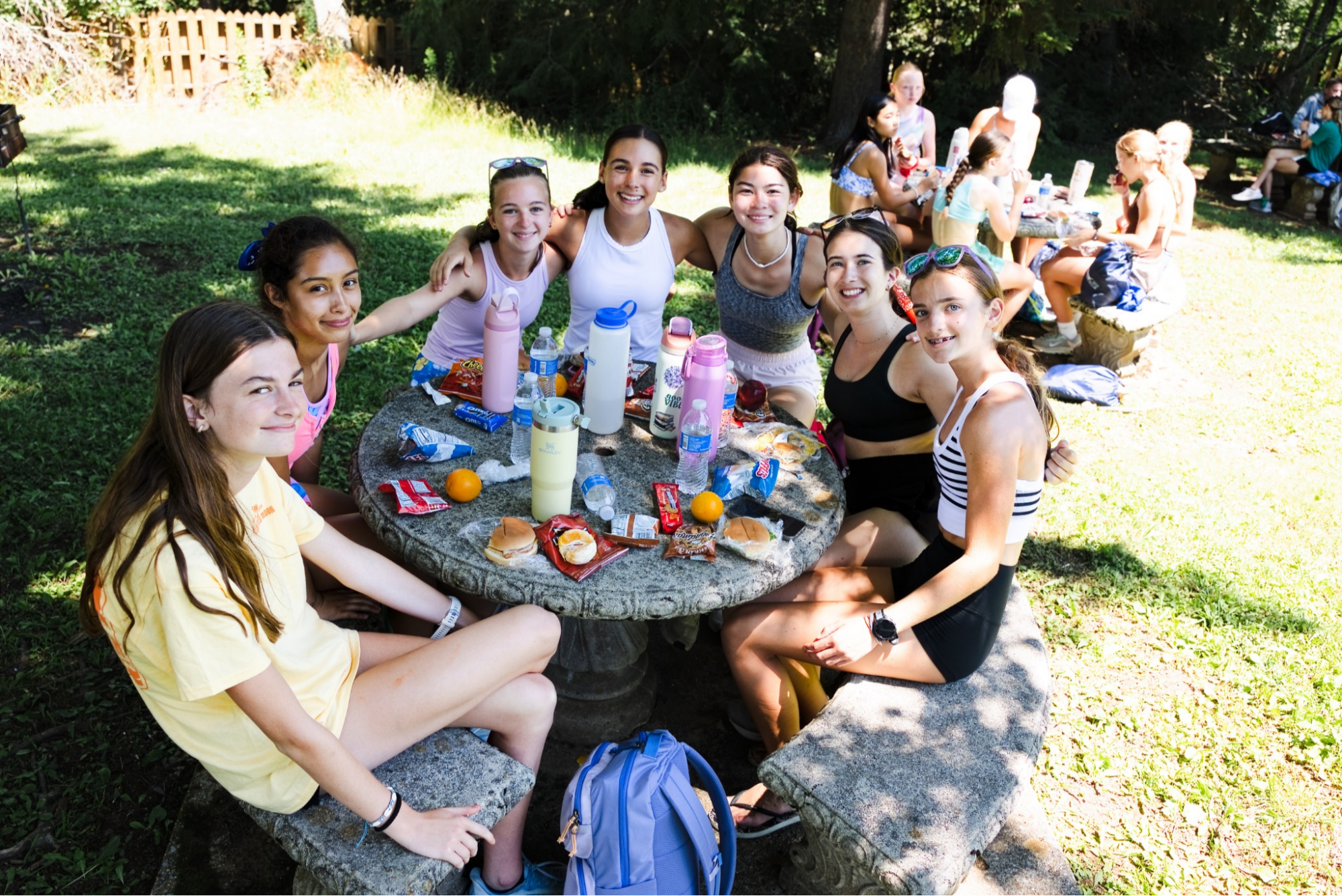 Campers enjoying lunch together outdoors