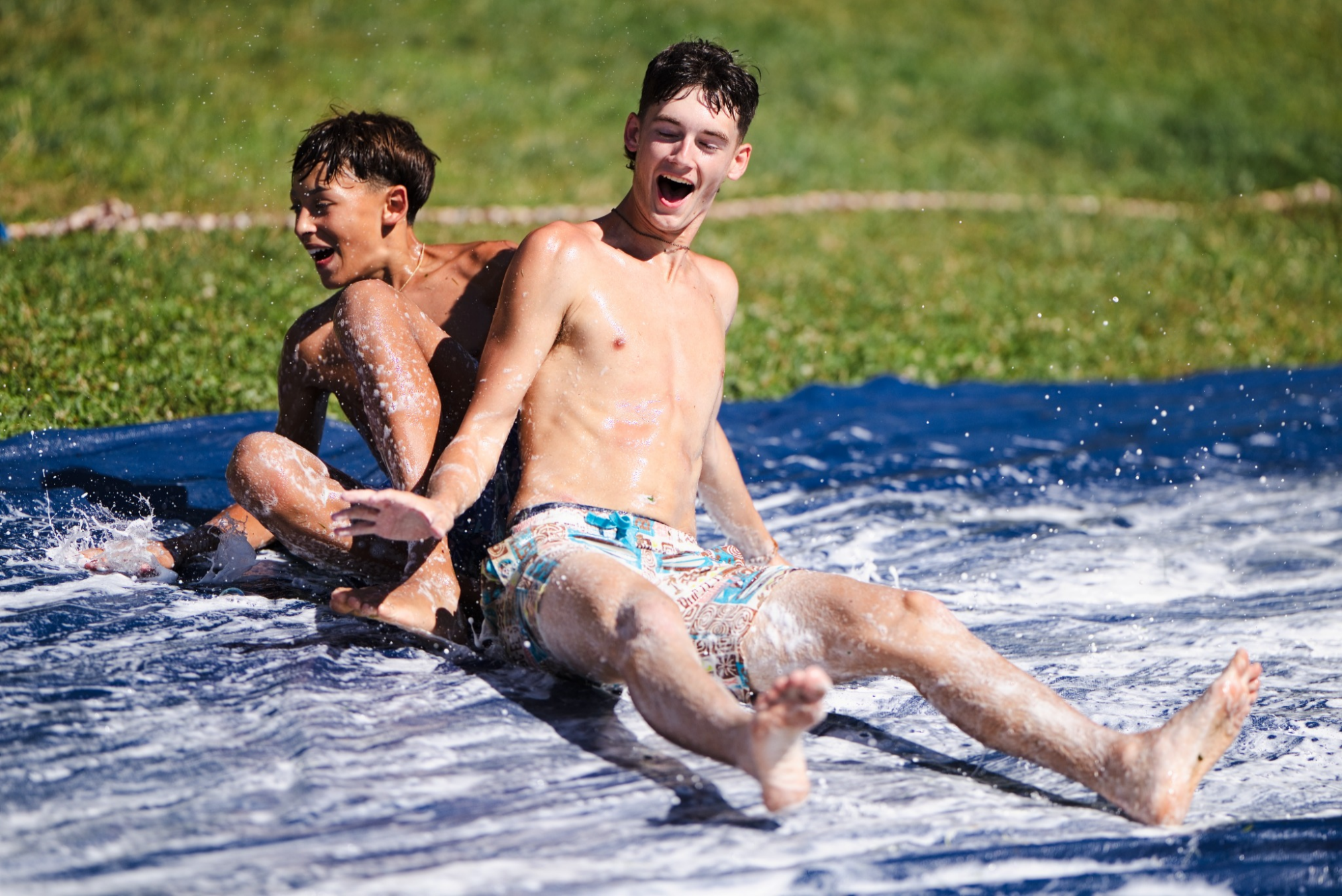 Boys enjoying the slip-and-slide at cross country camp