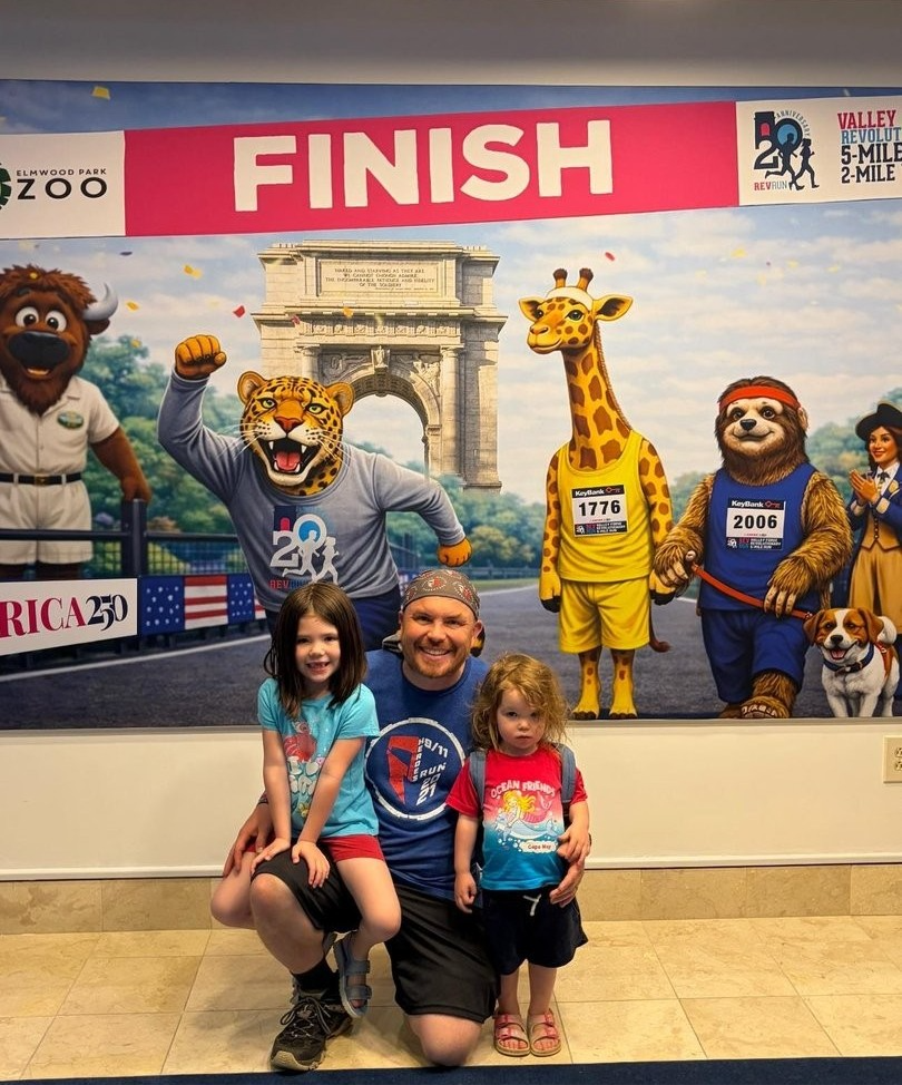 Father poses with two children at the 2026 Rev Run packet pickup