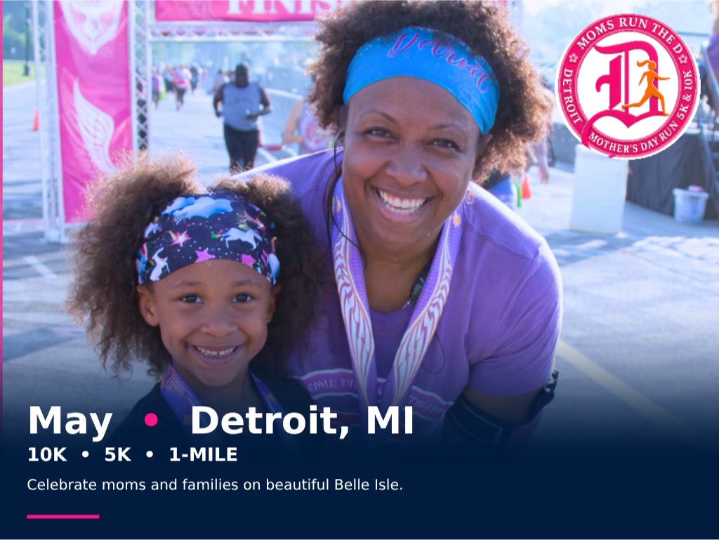 A mother and daughter smiling at the finish line of the Detroit Mother's Day run at Belle Isle, Michigan