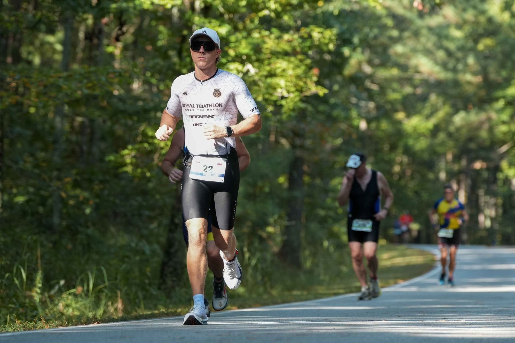 Triathlete running past spectators at the DeGray Lake Triathlon